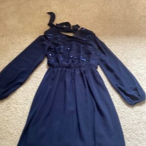 This is a navy blue dress with an open slit back